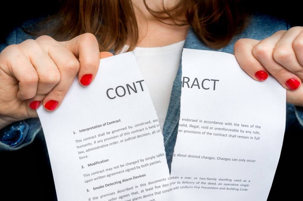 Image of contract being torn in half