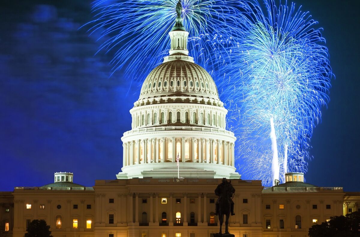 Image of the U.S. Capitol Building with fireworks in the background