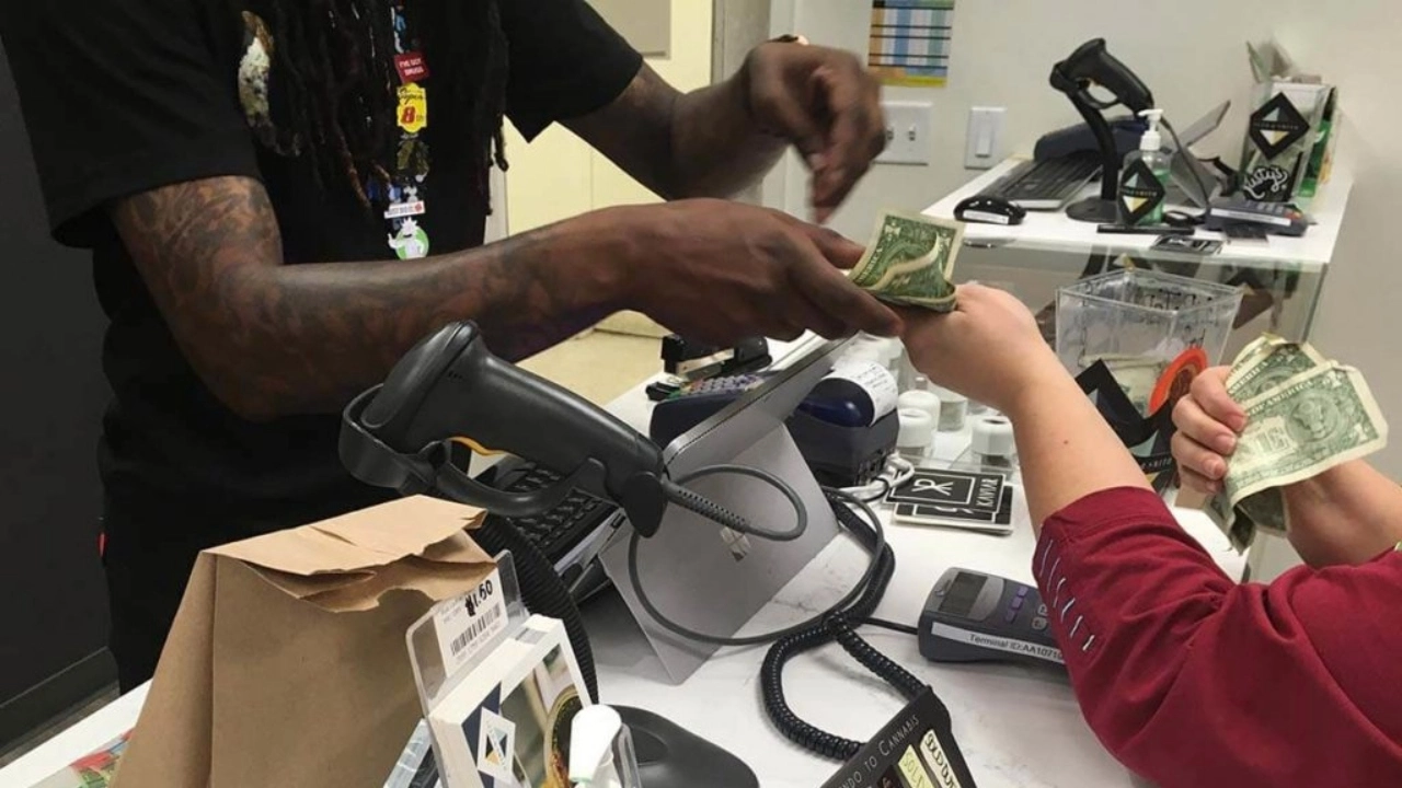 Image showing a cash transaction between a budtender and a customer