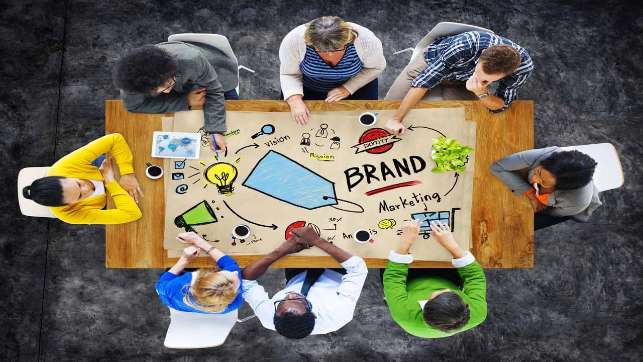 Image of diverse people at a table discussing branding and marketing