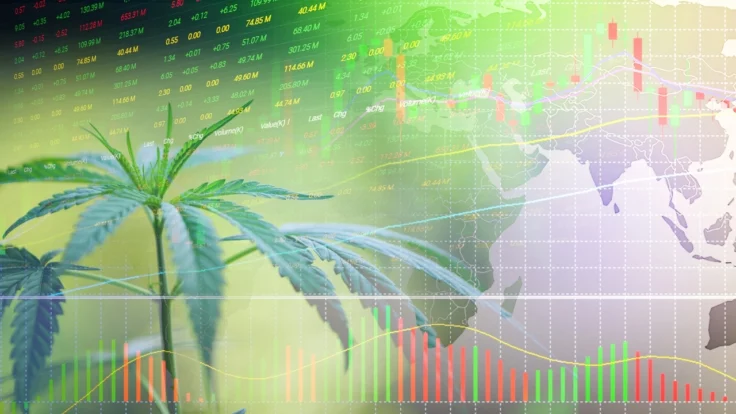 Image of a cannabis plant sitting in front of stock market figures, bar charts and a world map