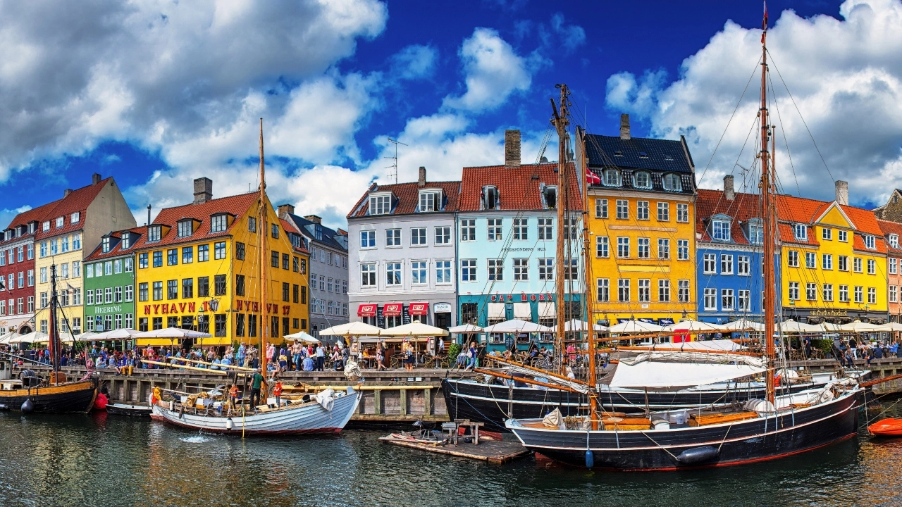 Image of colorful houses at Nyhavn in Copenhagen, Denmark, with boats in foreground