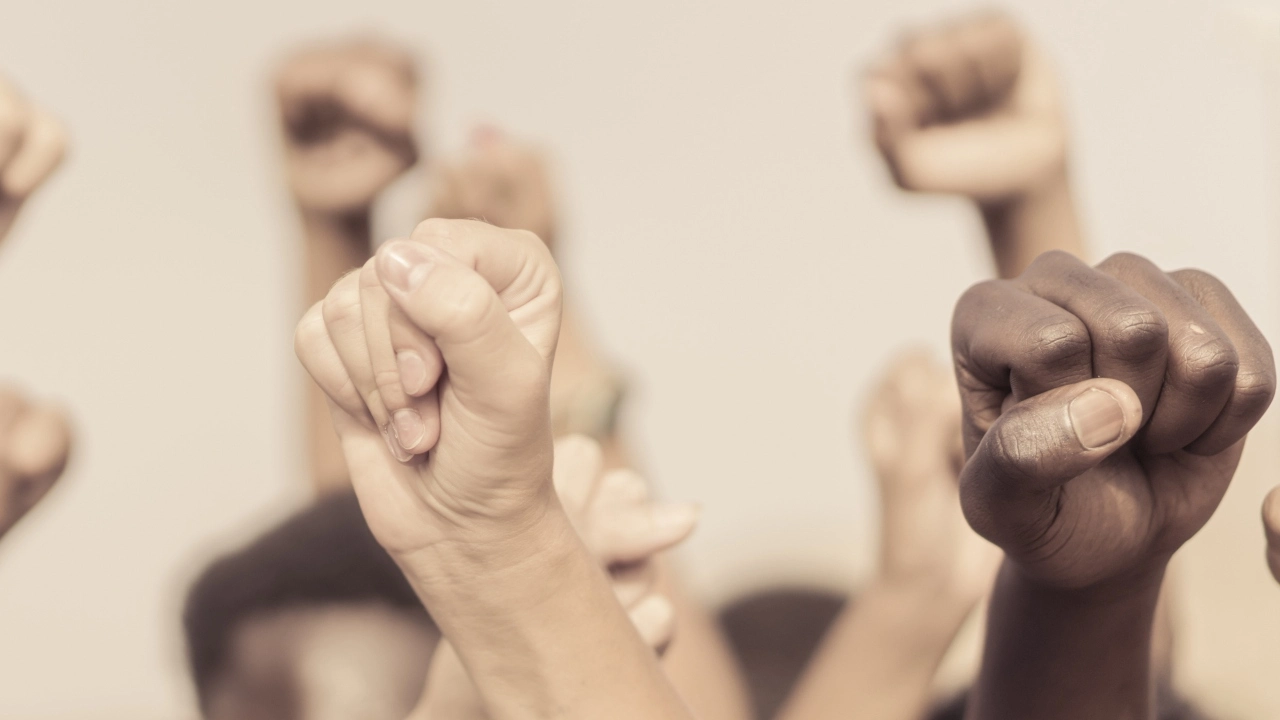Image of raised fists in the air