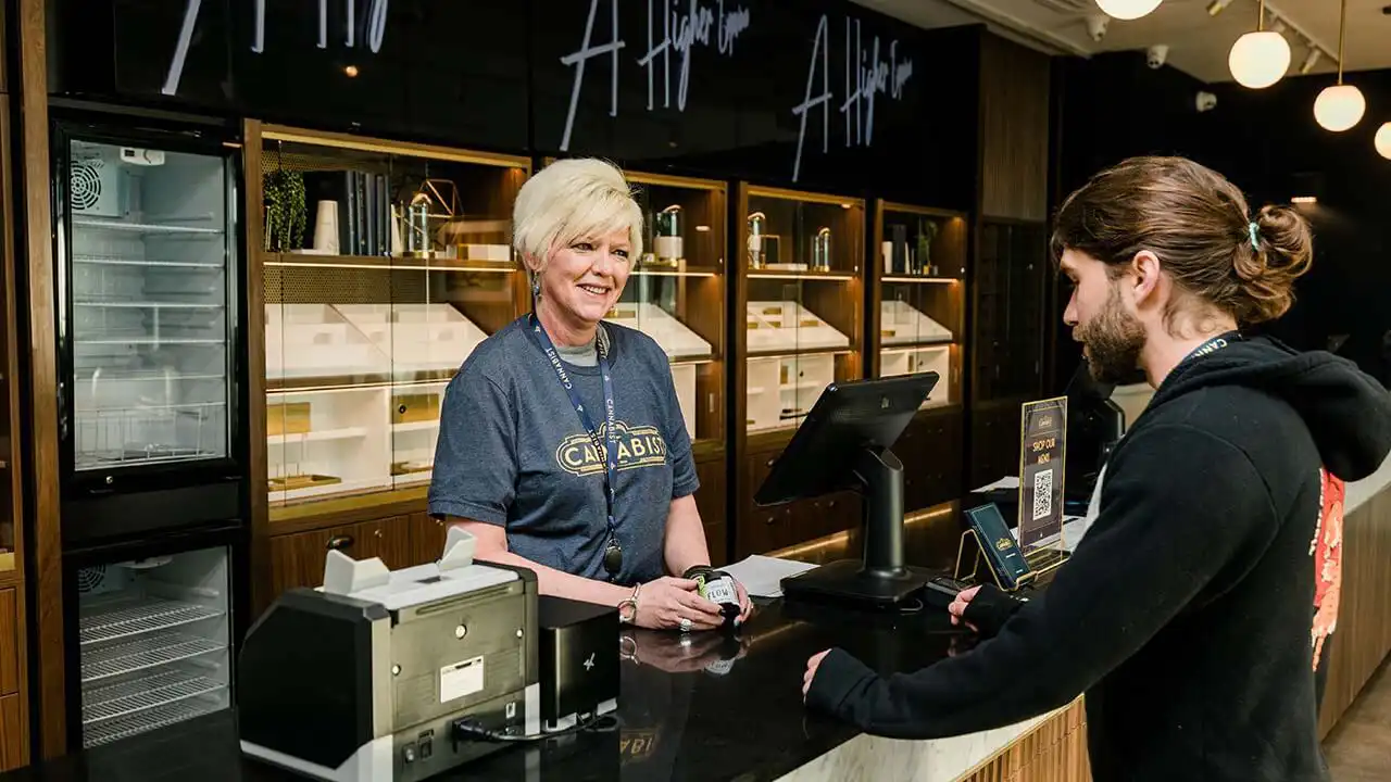 Image of customer making a purchase at a retail store owned by The Cannabist Co.