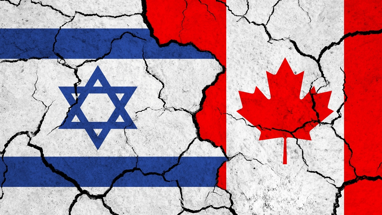 Image of Israel and Canada flags on a cracked surface.