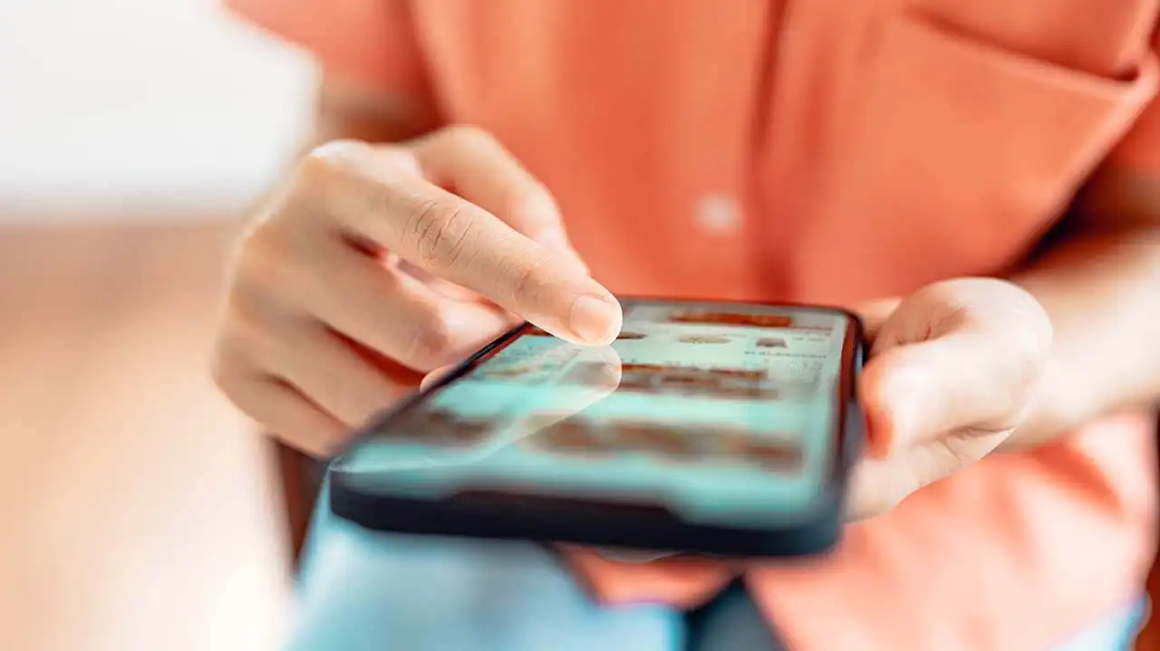 Image of a woman doing online shopping on her smartphone